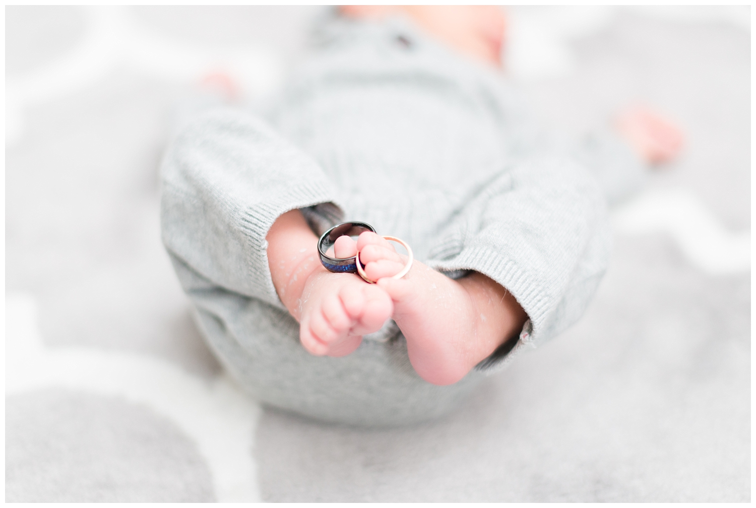 baby feet and wedding rings