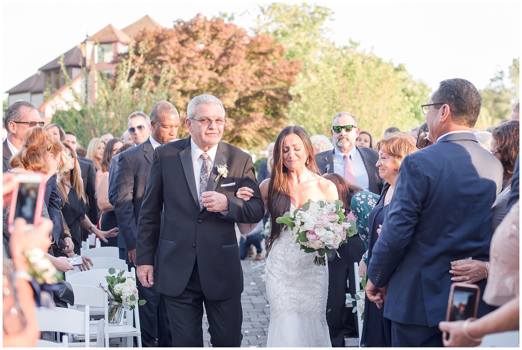 father of bride walks daughter down aisle