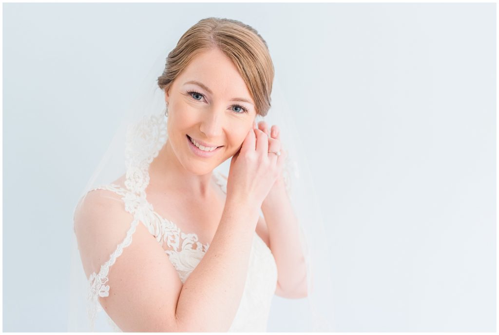 bride putting on earrings