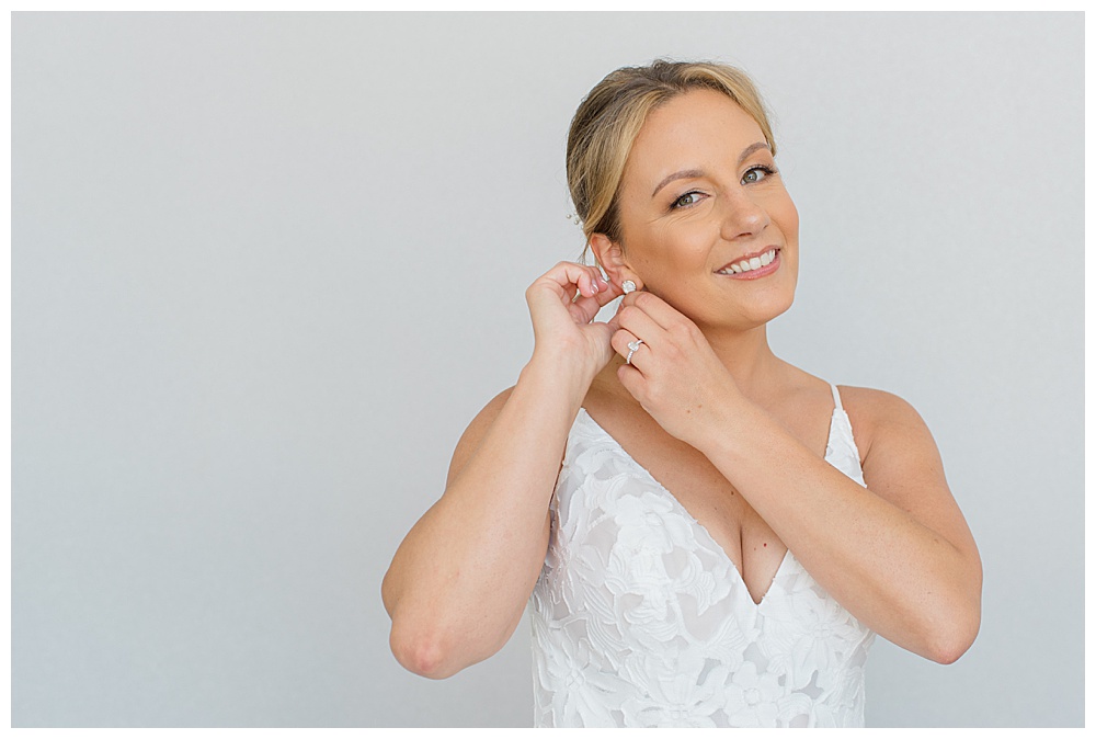 bride puts on earrings