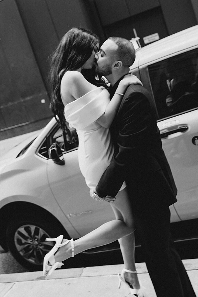 couple kissing in front of nyc taxi cab