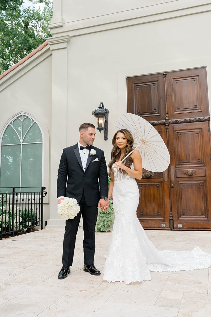 bride and groom with parasol