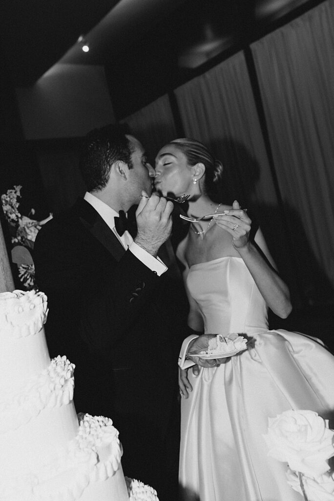 bride and groom eat wedding cake
