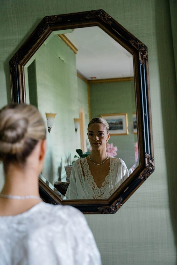 bride looks in mirror
