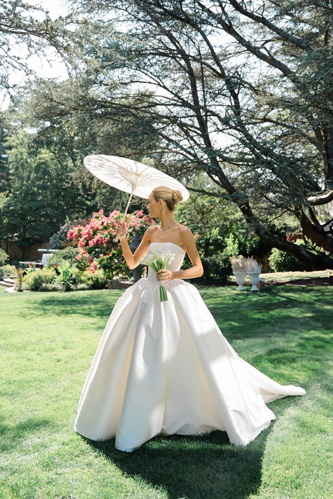 bride in strapless wedding dress with parasol